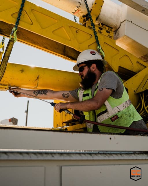 DC Power technician working on utility equipment